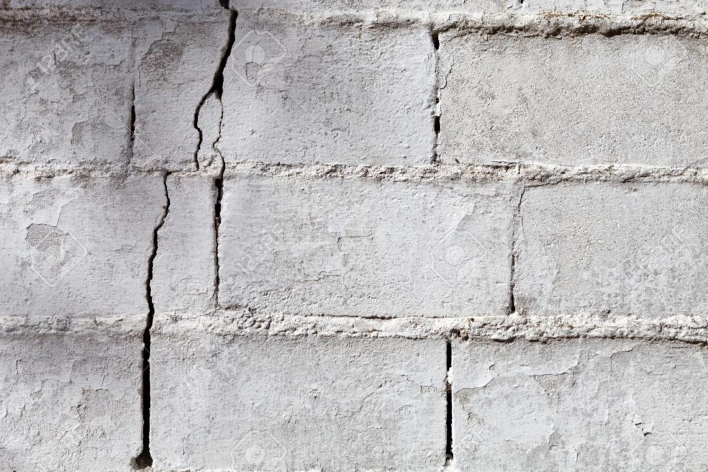 88607300 crack in a white wall with cement brick surface 1024x682 Foundation Cracks   How Do They Affect Your Home? Trenton, NJ